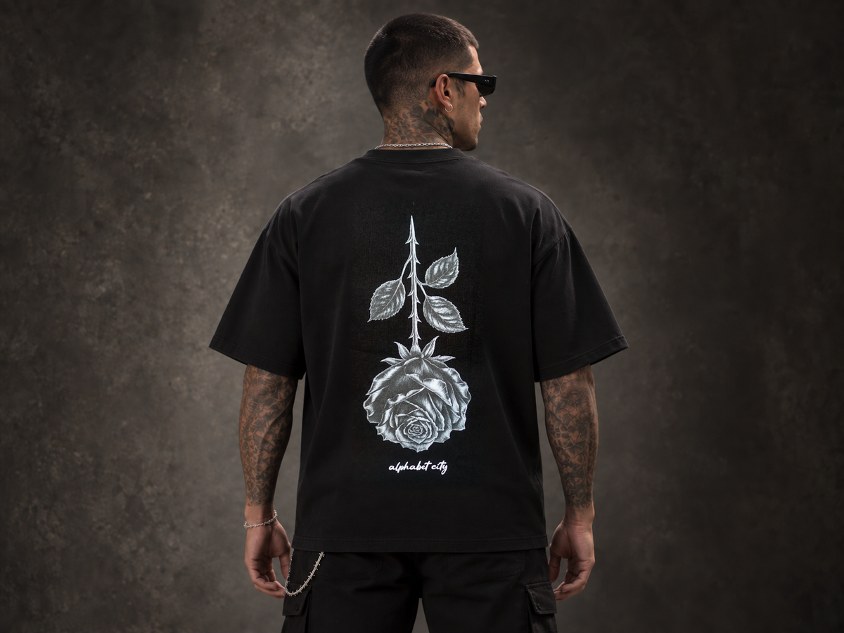 Back view of BLACK ROSE Tee in a studio.
