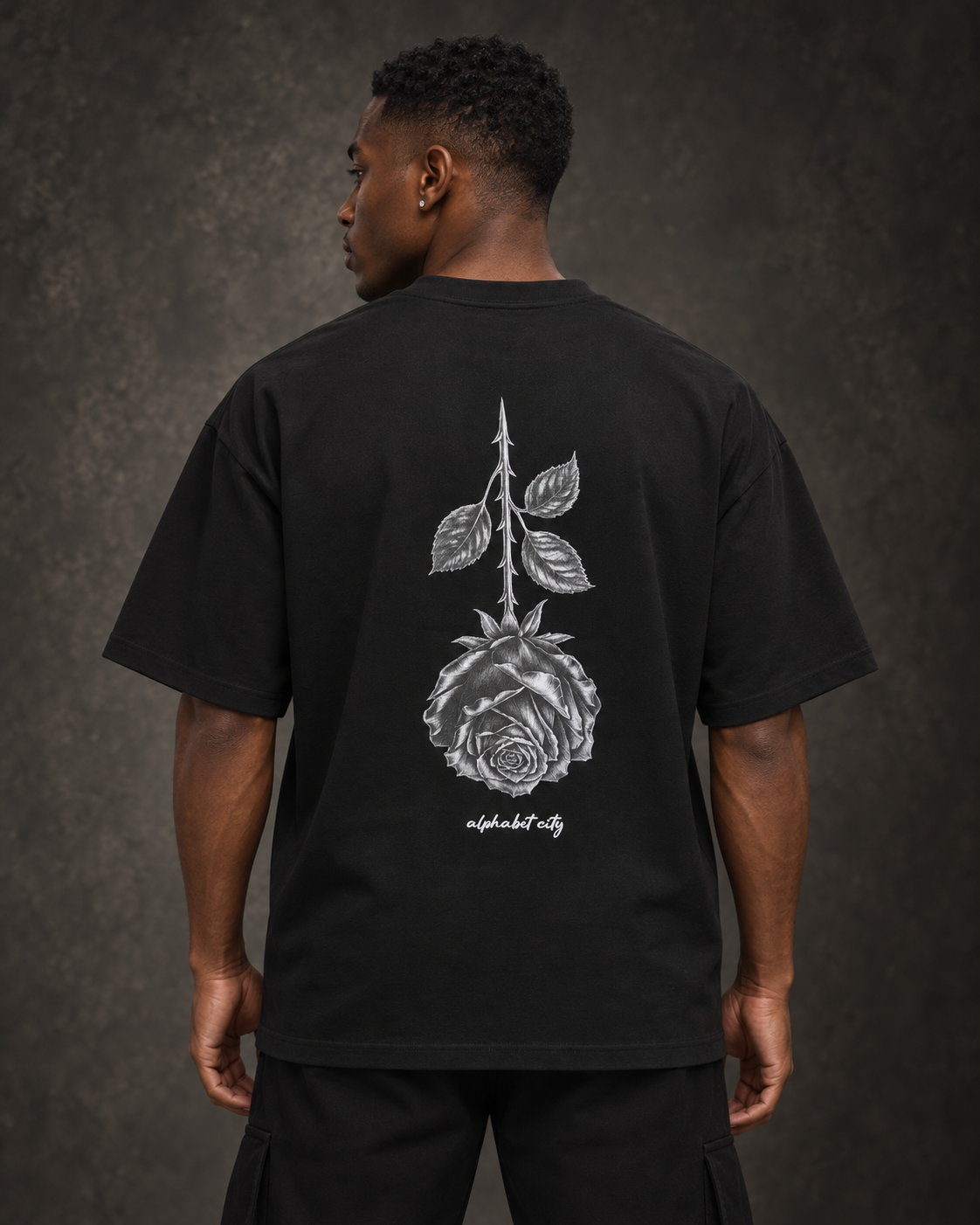 Back view of BLACK ROSE Tee in a studio.