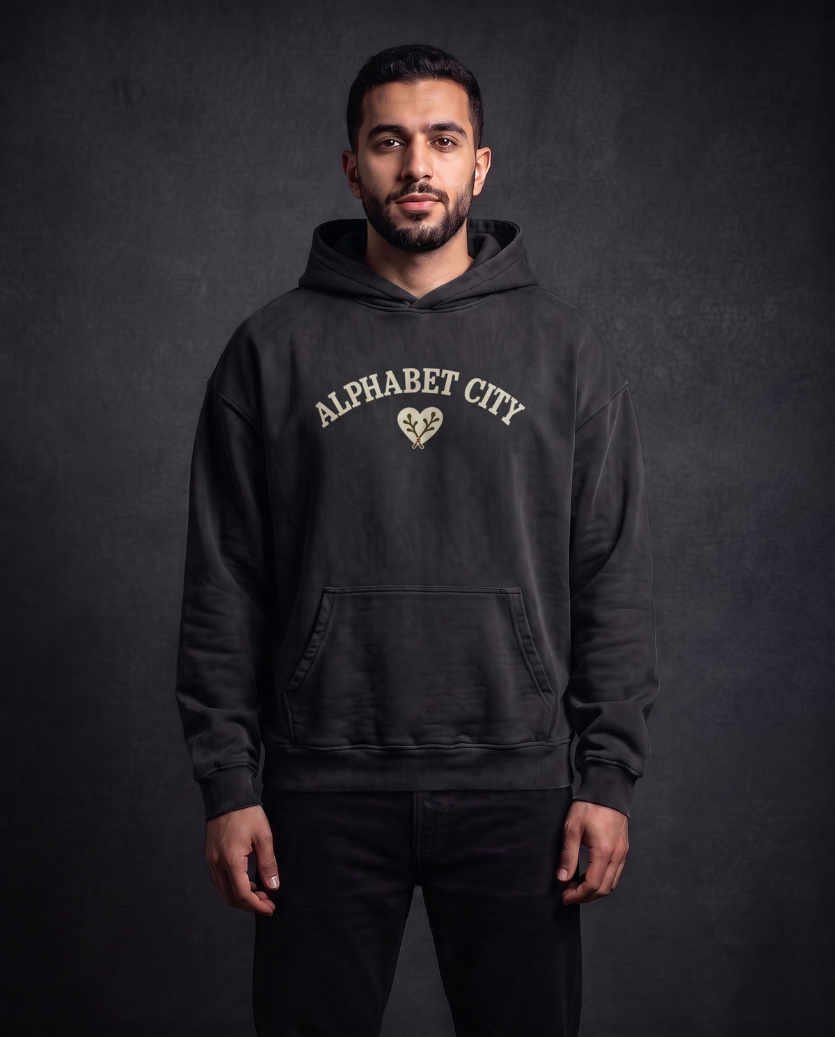 Model wearing the Heart Heavyweight Pullover Hoodie in Faded Black, front view