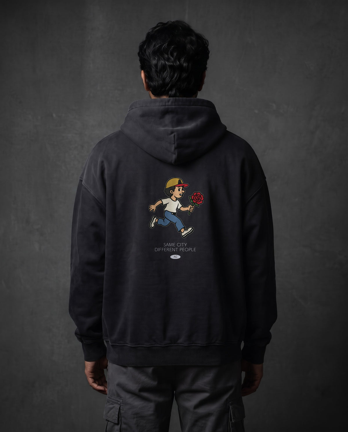 Model wearing the Rose Runner Heavyweight Pullover Hoodie in Faded Black, back view
