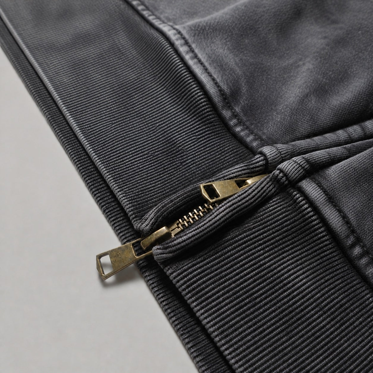Close-up of the BLACK ROSE Hoodie's two-way zipper, ribbed hem and snow-wash texture.